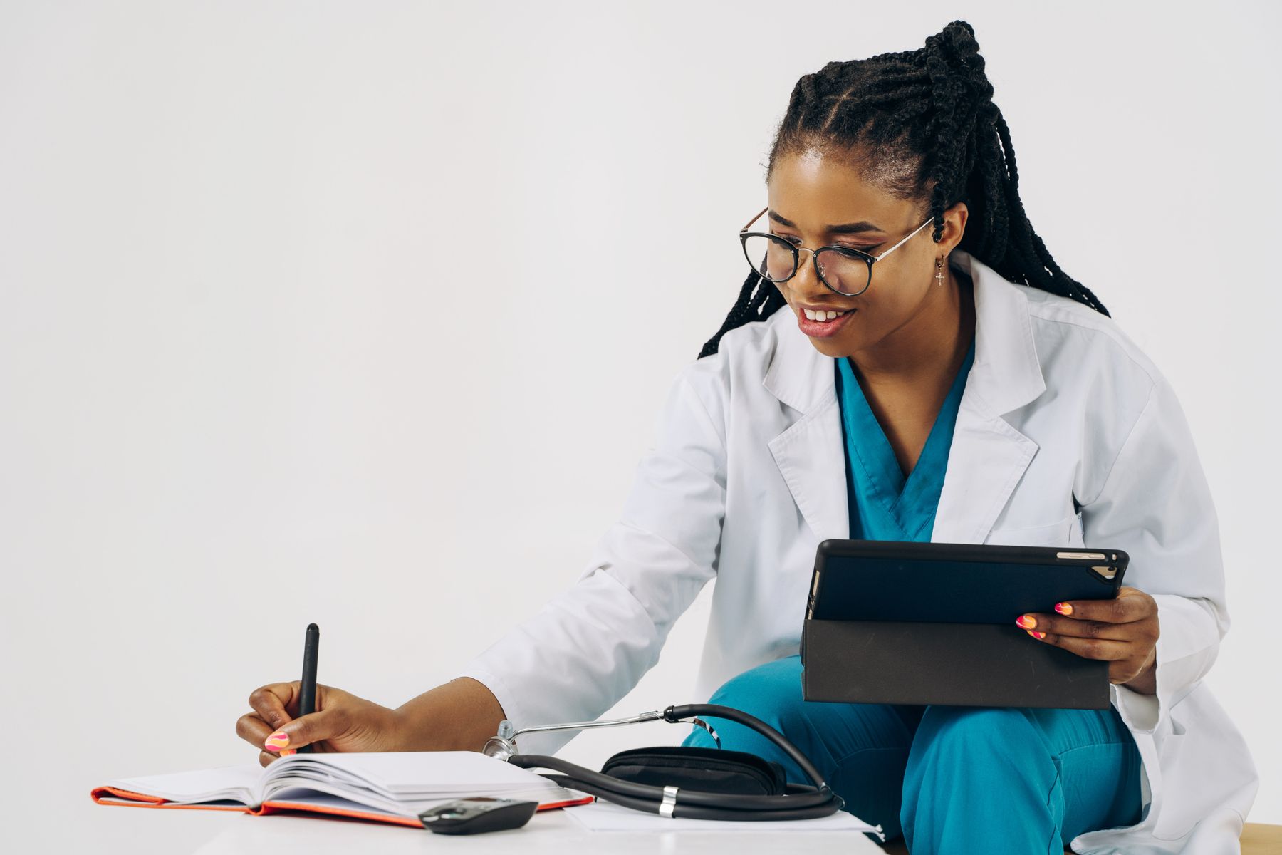 A clinician using a tablet while recording care notes